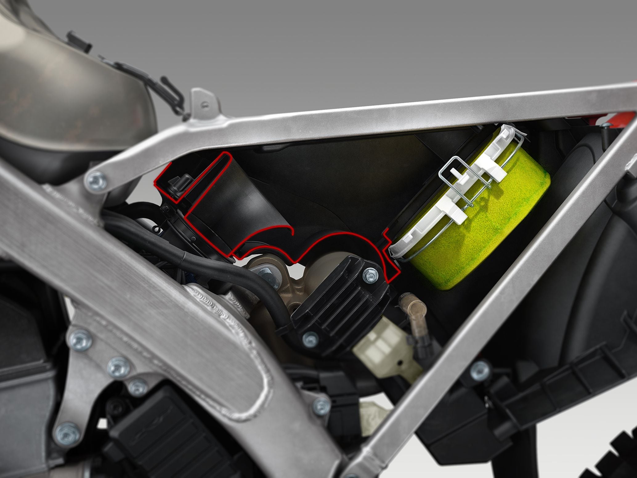 While the 2017–2020 CRF450R’s airboot capacity was 1.8 liters, the new generation machine’s has been enlarged to 4.1 liters. The air filter is a different size and shape, and the airbox is now accessible with the removal of a single bolt on the side panel.